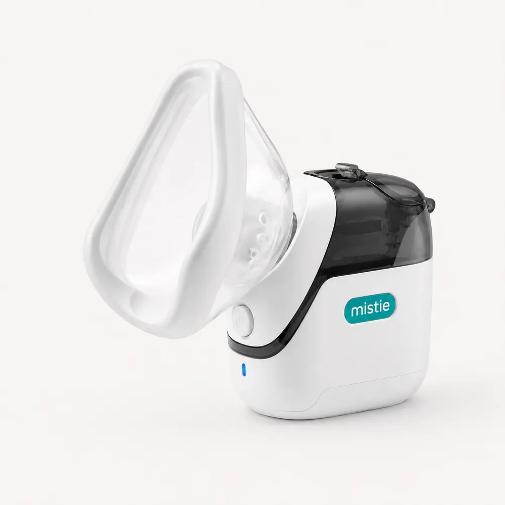 Mistie mesh nebulizer with mask attached on a light background